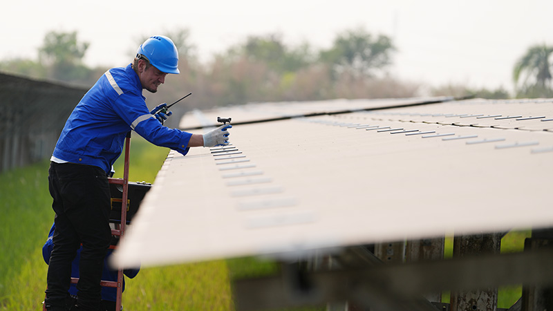 man working on solar panel