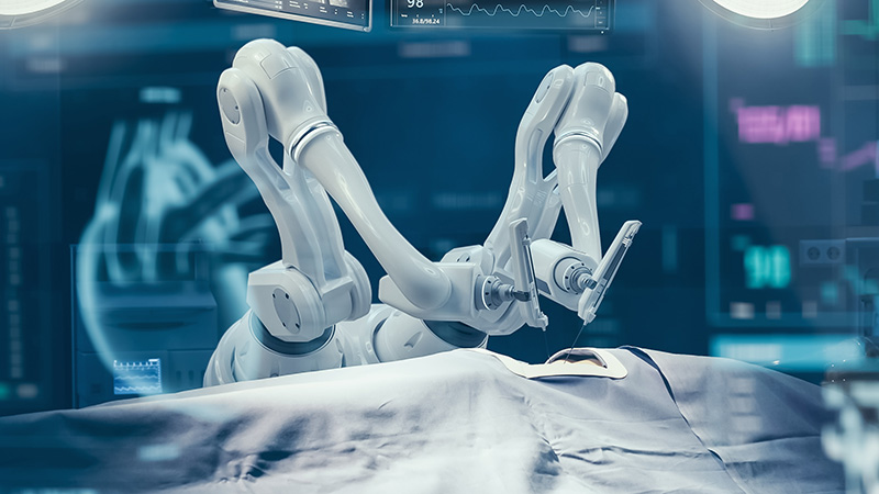 robotic arms at an operating table